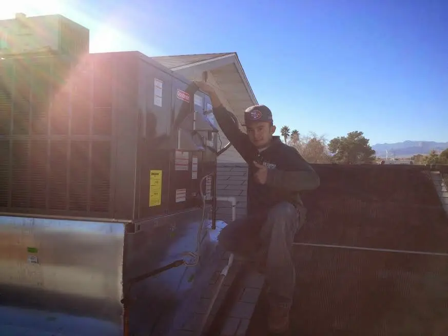 HVAC technician performing Boiler Repair on a rooftop unit in Sioux Falls